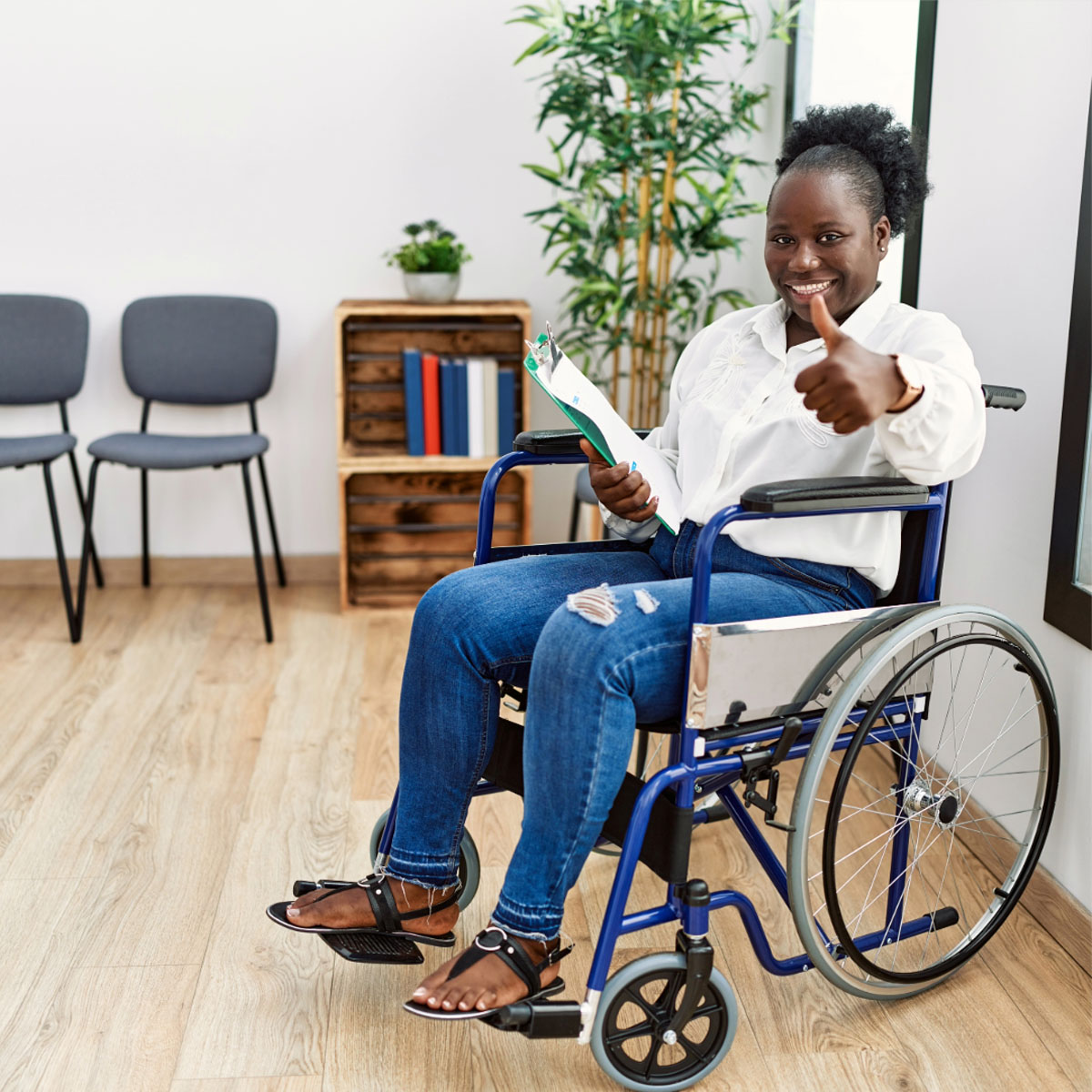 woman in wheelchair thumbs up